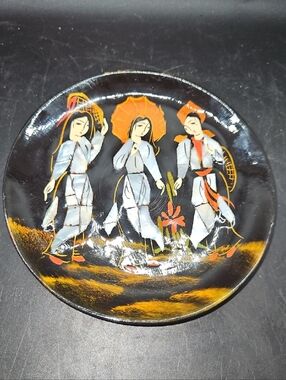 Vintage-Style Black Decorative Plate with Orange and White Figurative Design